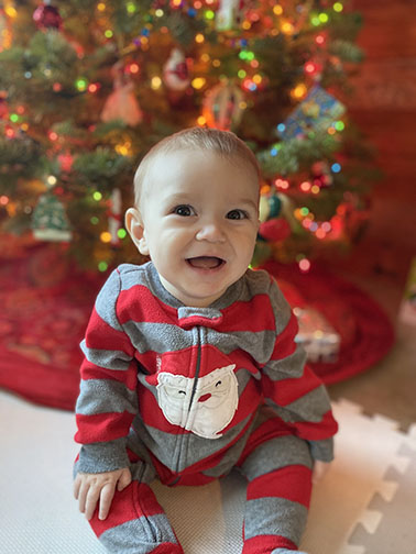 Patrick, Roarty’s son, smiles by the Christmas tree.