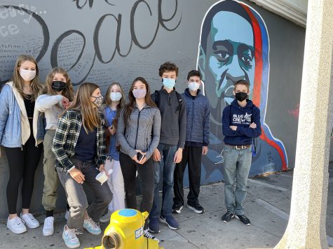 Mask-wearing freshmen gather in front of the George Floyd mural in downtown Santa Barbara.