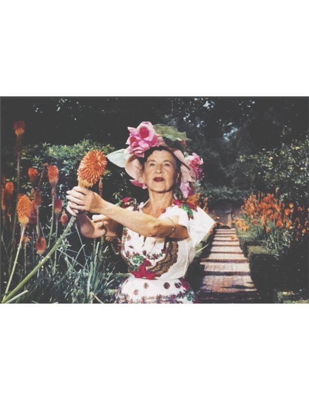 Madame Ganna Walska holding a torch lily in the Aloe Garden of Lotusland in 1957.